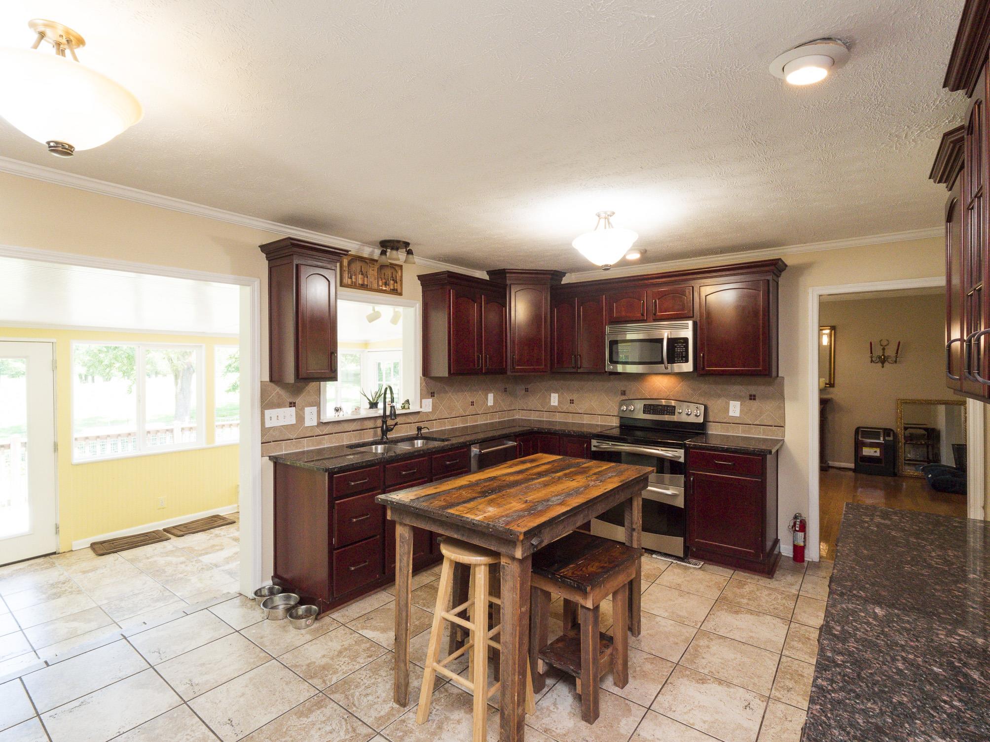 3609 Raymond Head Road Springfield, TN 37172 - Photo 10 of 30 a kitchen with stainless steel appliances kitchen island granite countertop a sink and cabinets