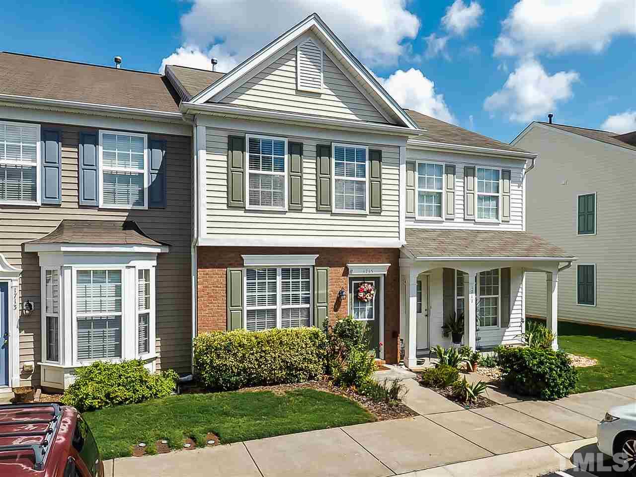 1715 Grace Brook Road Raleigh, NC 27609 - Photo 2 of 20 front view of a brick house with a yard