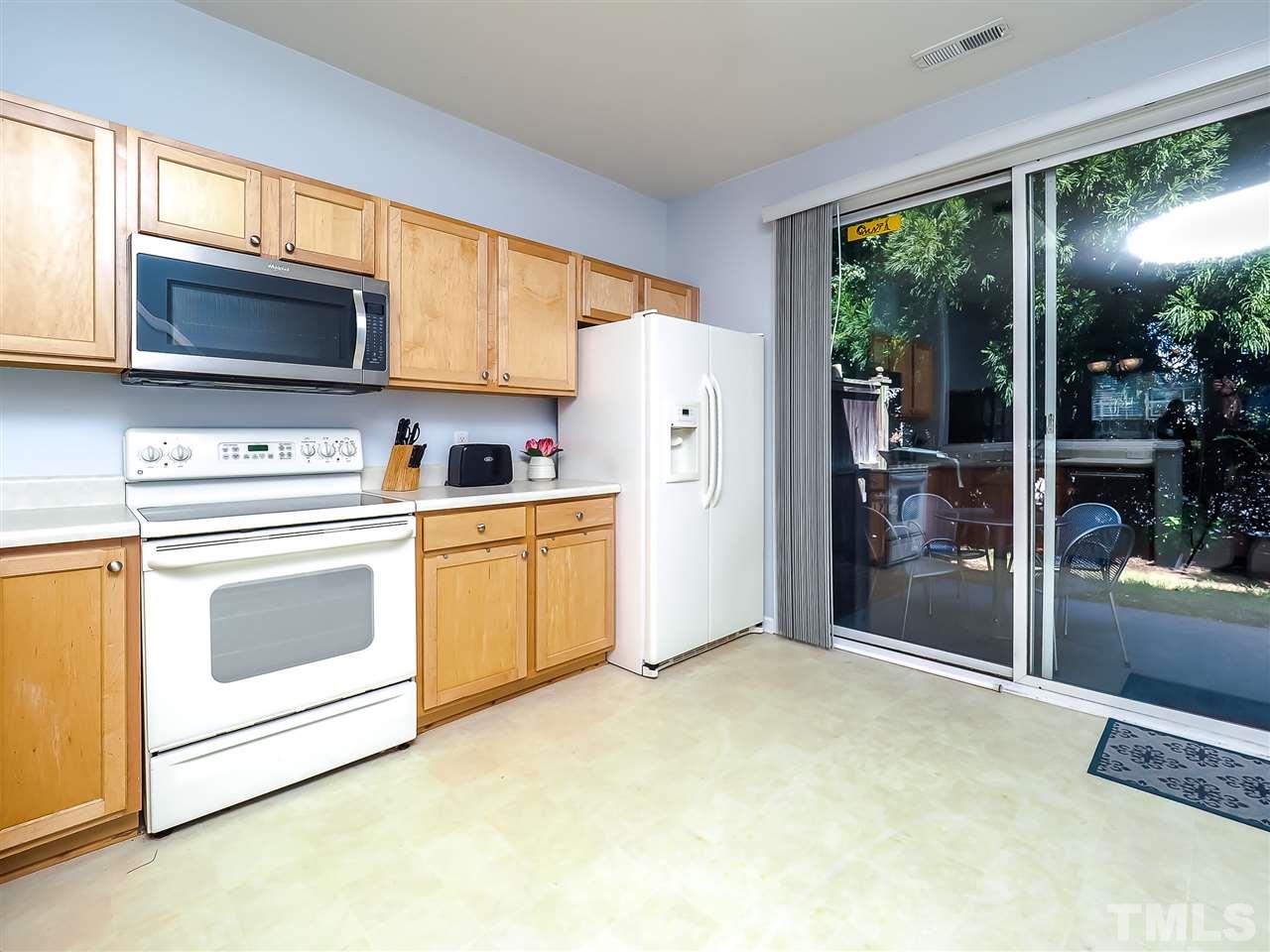 1715 Grace Brook Road Raleigh, NC 27609 - Photo 11 of 20 a kitchen with stainless steel appliances a stove a refrigerator sink and cabinets