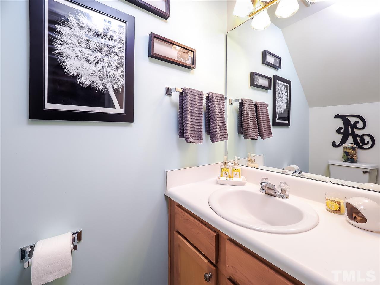 1715 Grace Brook Road Raleigh, NC 27609 - Photo 13 of 20 a bathroom with a sink and a mirror