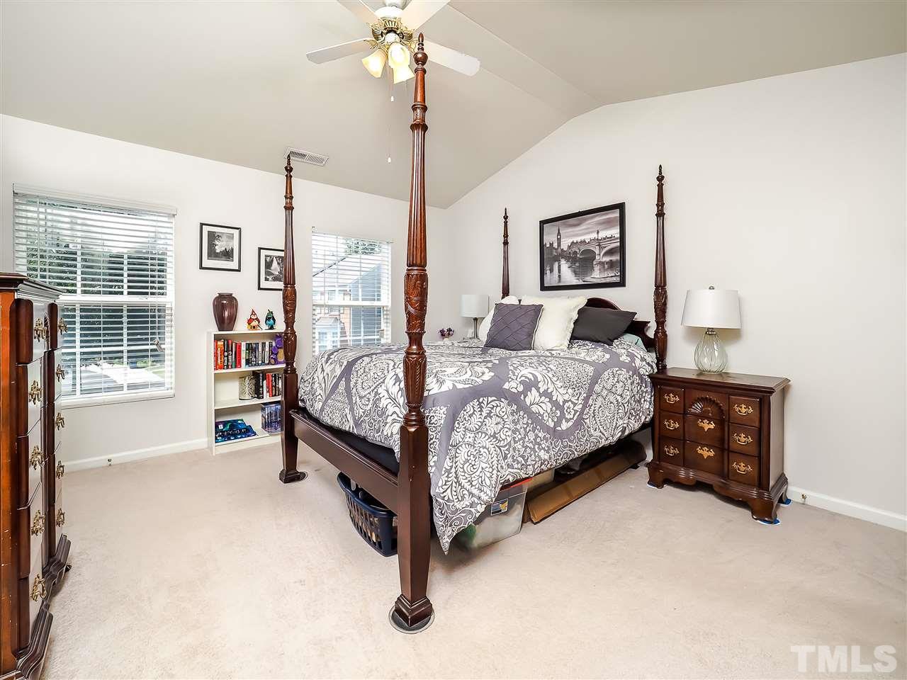 1715 Grace Brook Road Raleigh, NC 27609 - Photo 14 of 20 a bedroom with a bed a table and painting