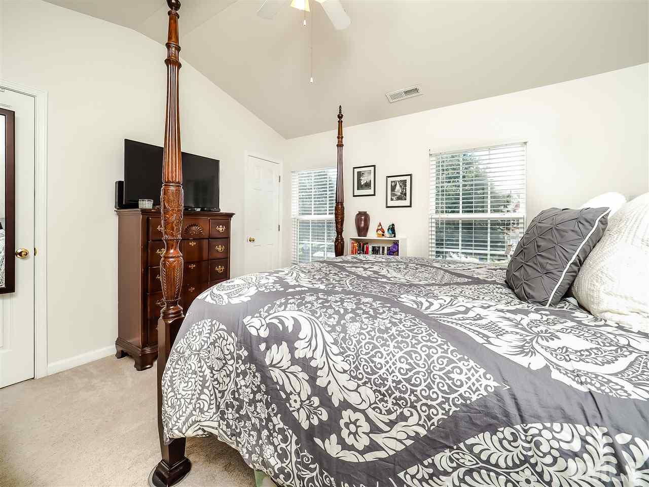 1715 Grace Brook Road Raleigh, NC 27609 - Photo 15 of 20 a living room with a bed furniture and a flat screen tv