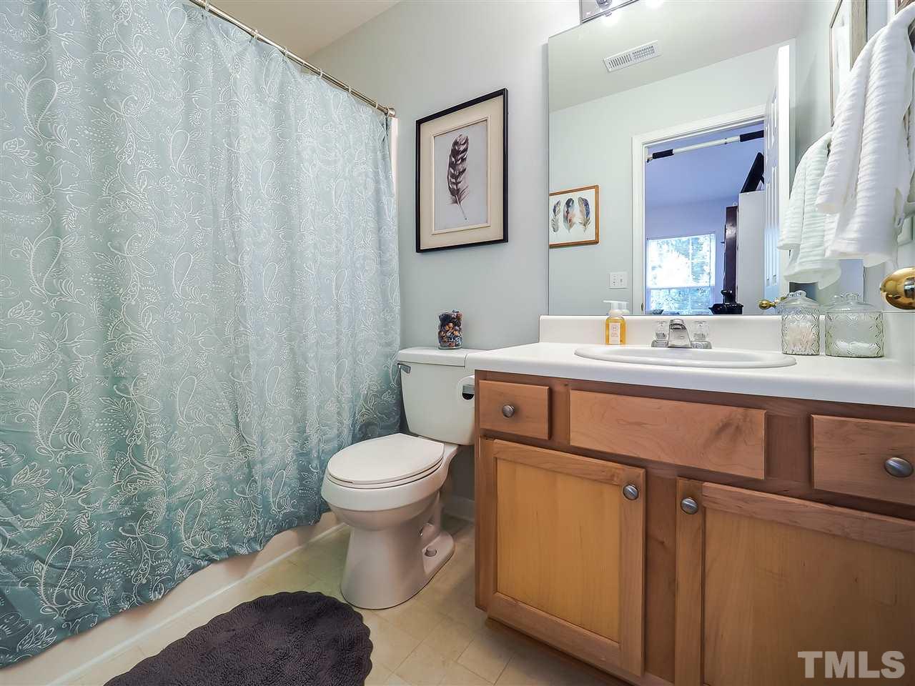 1715 Grace Brook Road Raleigh, NC 27609 - Photo 19 of 20 a bathroom with a sink toilet and vanity