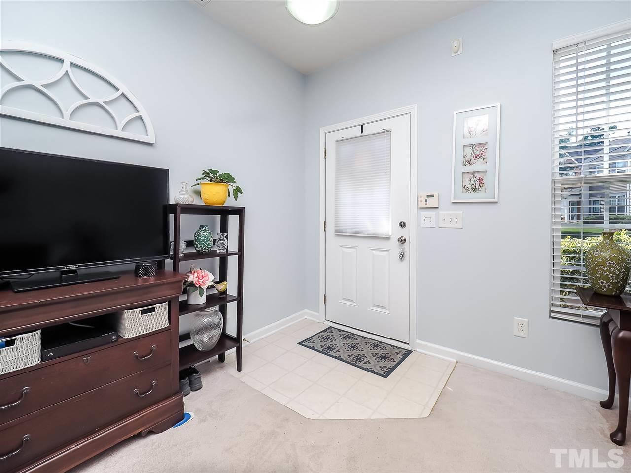 1715 Grace Brook Road Raleigh, NC 27609 - Photo 5 of 20 a living room with furniture and a flat screen tv