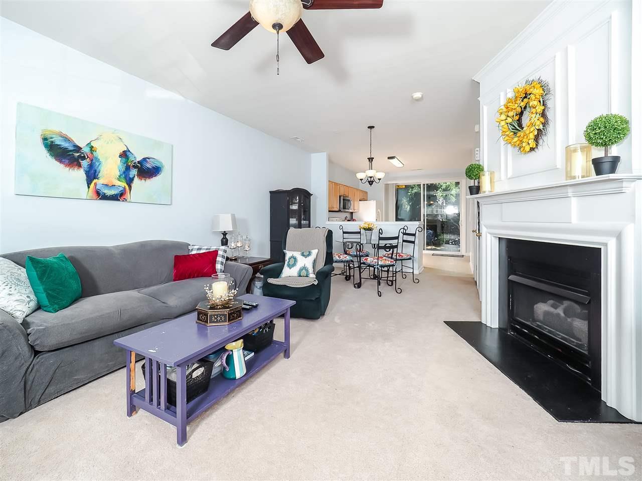 1715 Grace Brook Road Raleigh, NC 27609 - Photo 7 of 20 a living room with furniture and a fireplace
