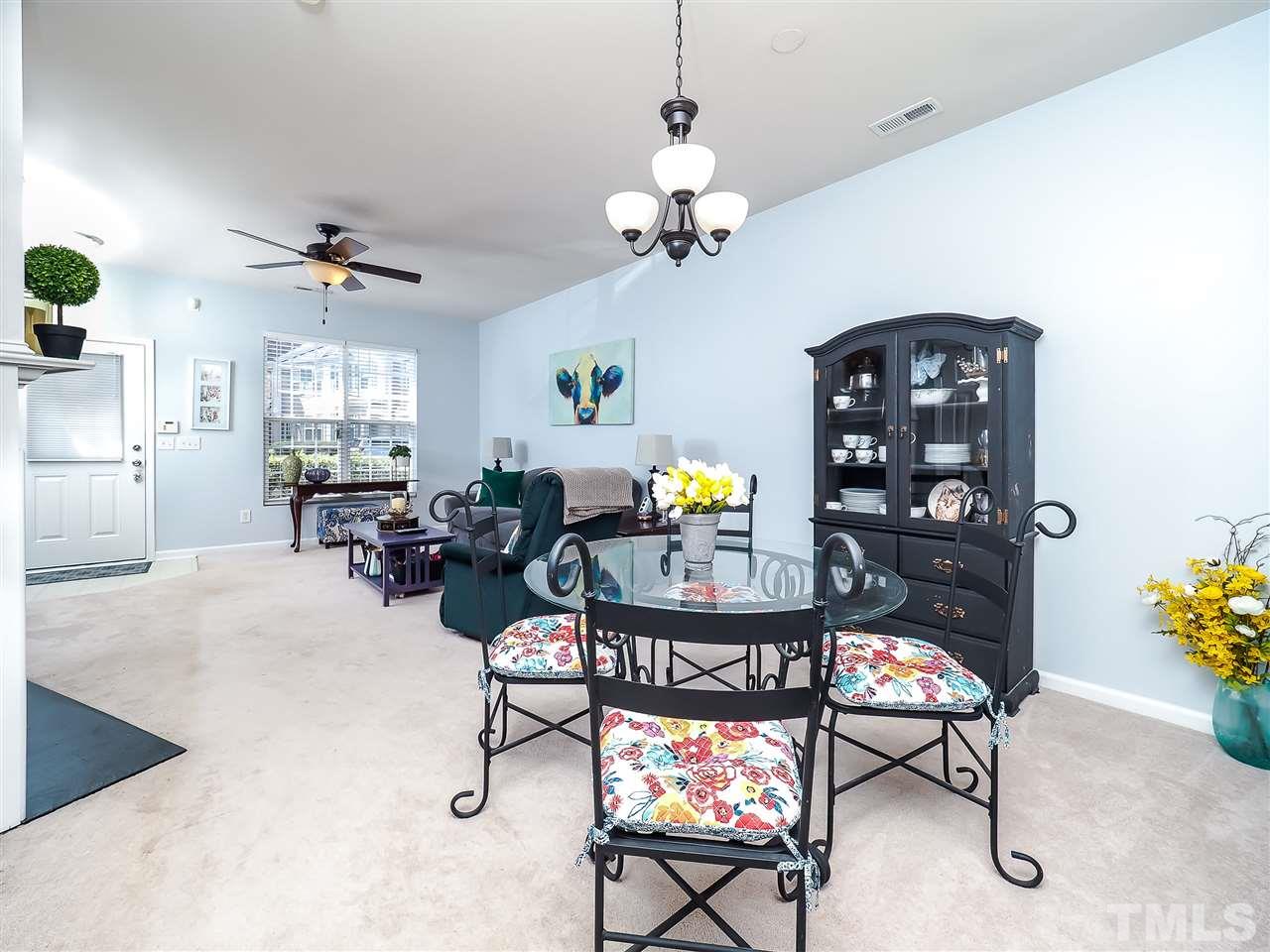 1715 Grace Brook Road Raleigh, NC 27609 - Photo 10 of 20 a living room with furniture a chandelier and a window