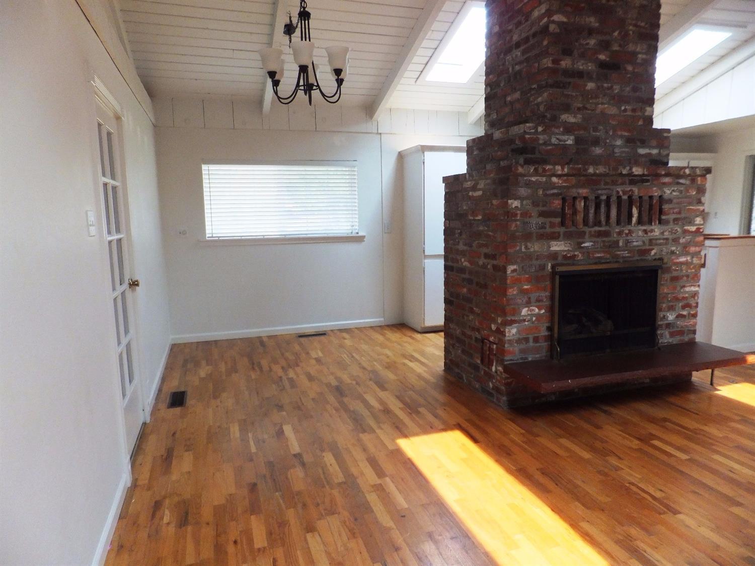 1312 Talent Avenue Talent, OR 97540 - Photo 6 of 21 a view of empty room with wooden floor and fireplace