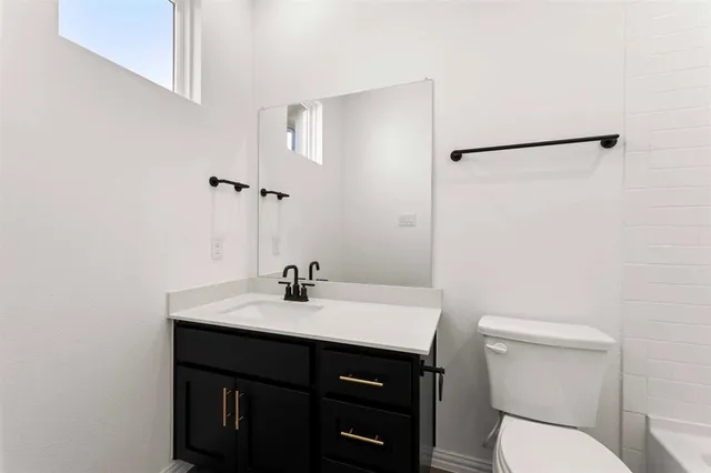 a bathroom with a sink toilet and vanity