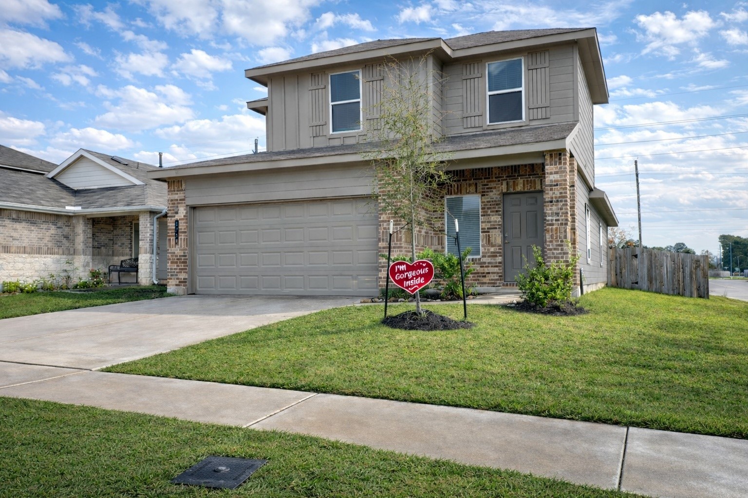 a view of a house with a yard and a garage