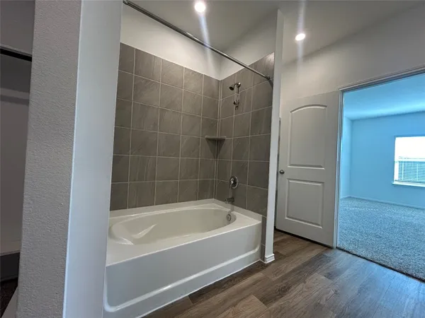 a bathroom with a bathtub and a shower