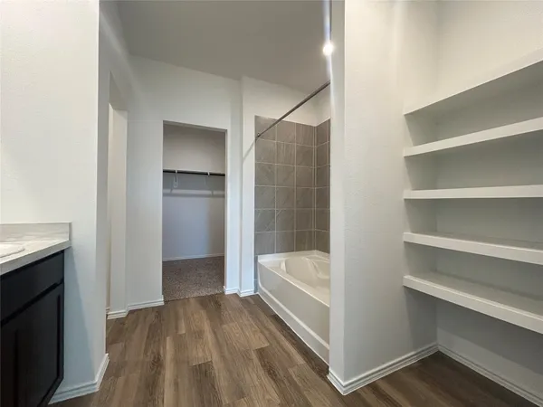 a bathroom with a bathtub and a sink