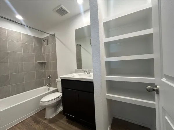 a bathroom with a toilet a sink and bathtub
