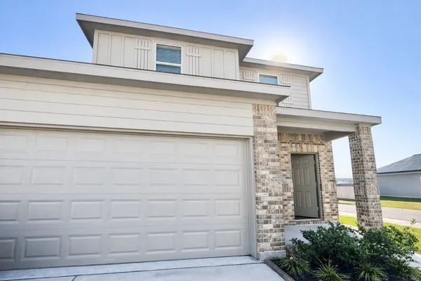 a front view of a house with plants