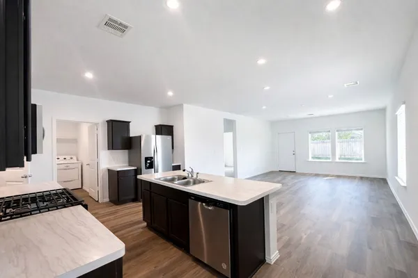 a kitchen with a sink stove and refrigerator