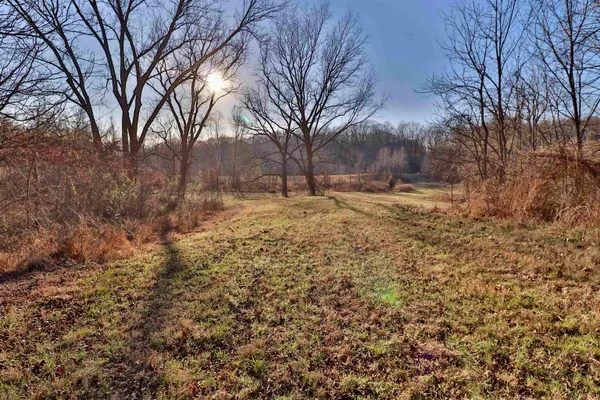 a view of a yard covered with snow in front of house