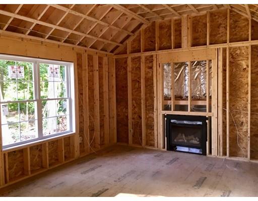 46 Berwick Road Attleboro, MA 02703 - Photo 2 of 6 a view of an empty room with a fireplace and a window