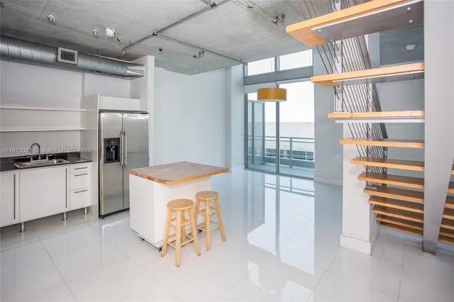 a kitchen with a refrigerator and a stove