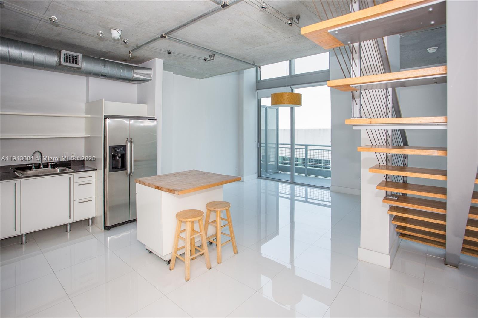 a kitchen with a refrigerator and a stove