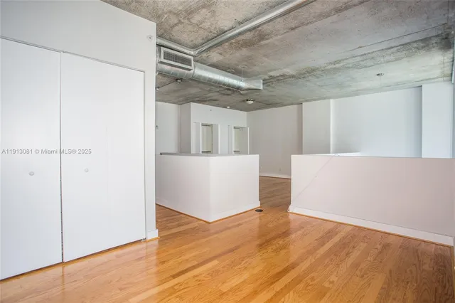 a view of a room with wooden floor