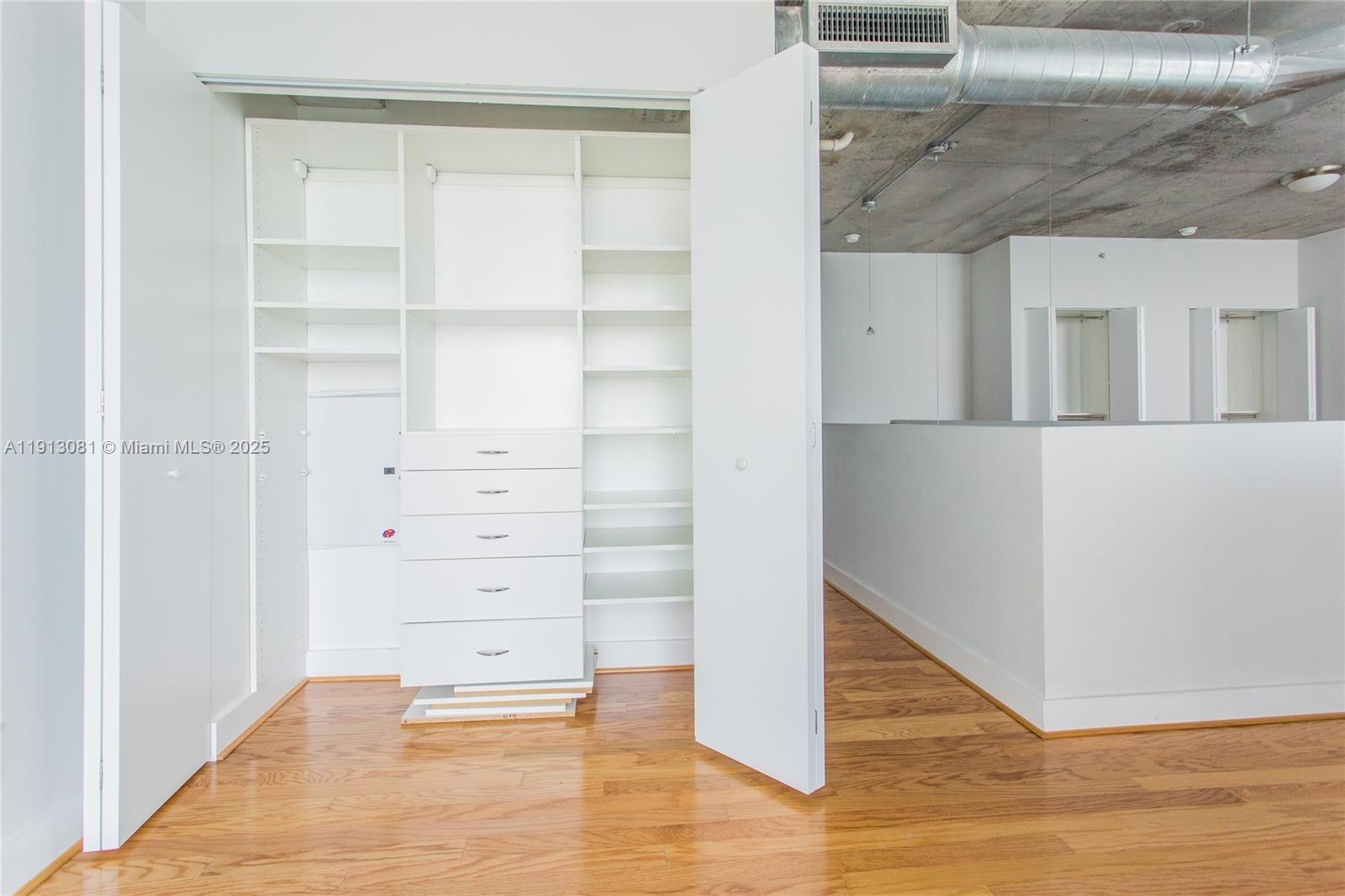 690 Southwest 1st Court, Unit PHI20 Miami, FL 33130 - Photo 7 of 21 a view of walk in closet with empty racks