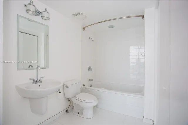 a bathroom with a toilet a sink and a bathtub