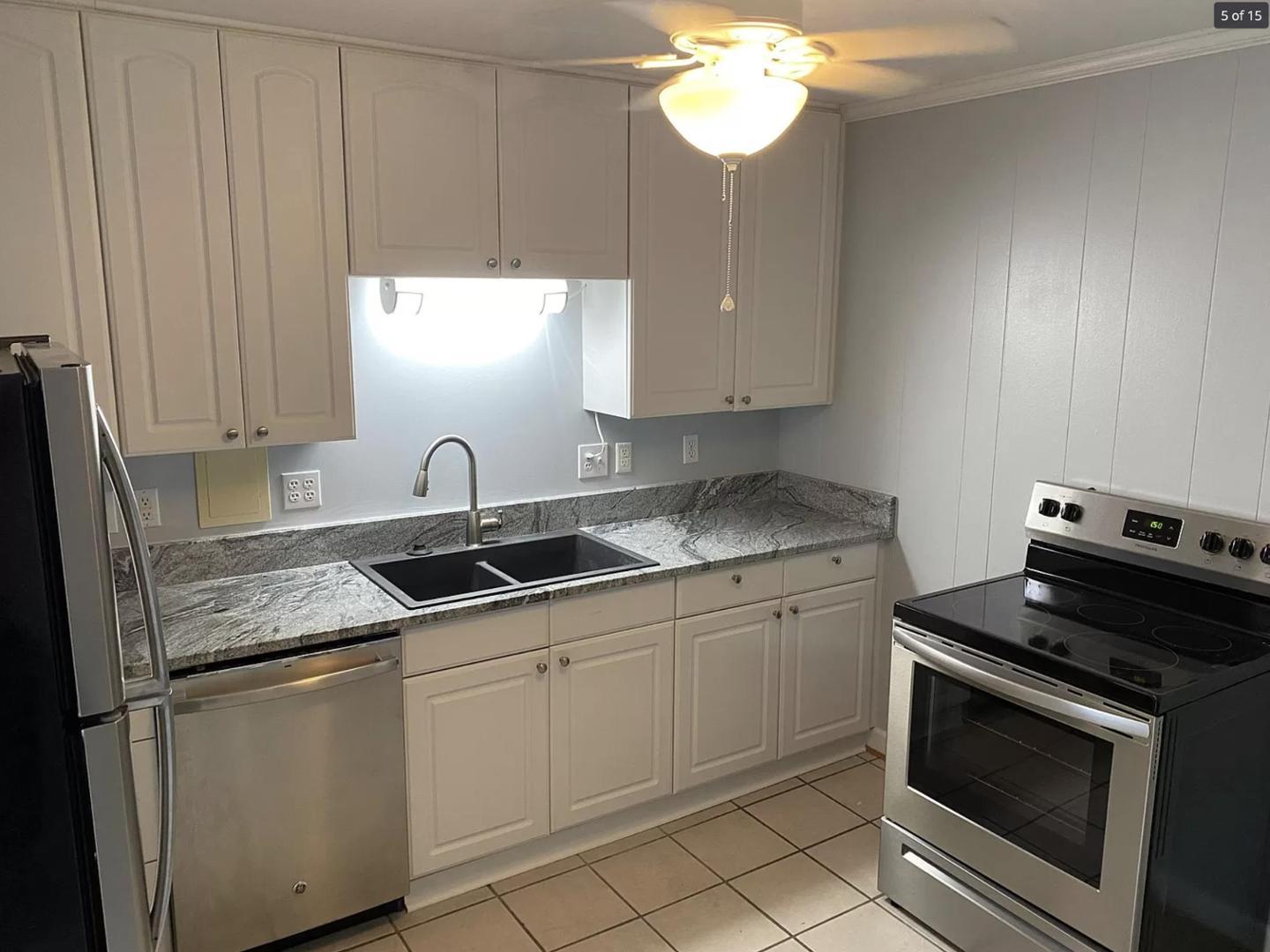 1416 Old Lystra Road, Unit 2 Chapel Hill, NC 27517 - Photo 1 of 12 a kitchen with stainless steel appliances granite countertop a sink stove and cabinets