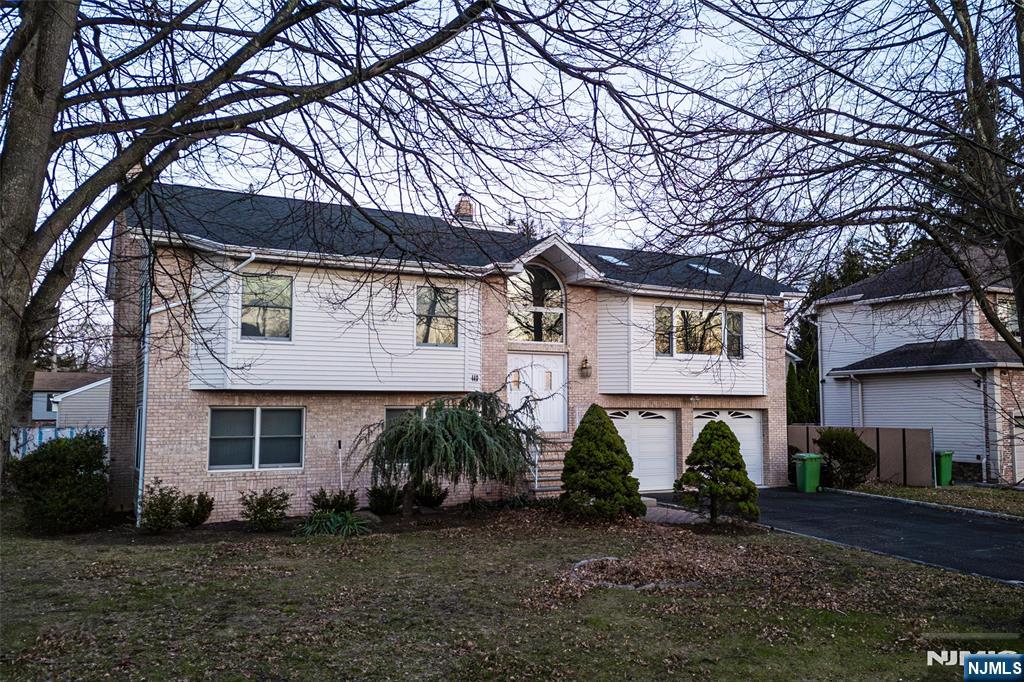 440 Holly Avenue Paramus, NJ 07652 - Photo 2 of 4 a front view of a house with garden