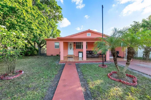 a front view of a house with a yard table and chairs