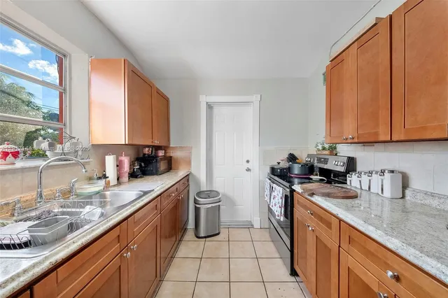 a kitchen with a sink stove and cabinets