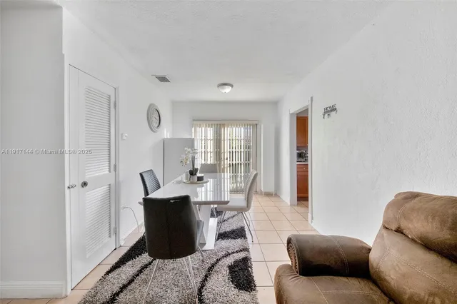 a living room with furniture a wooden floor and a window