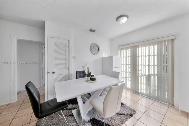 a view of a dining room with furniture and a large window