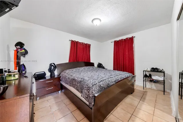 a bed room with a bed and a chair