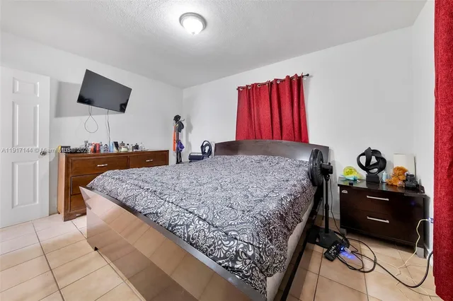 a bedroom with a bed and a flat screen television