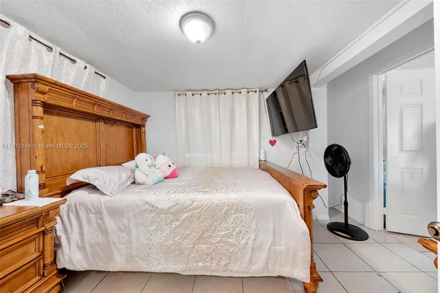 a bedroom with a bed and a flat tv screen