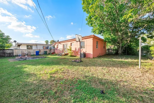 a house view with a play ground in front of it
