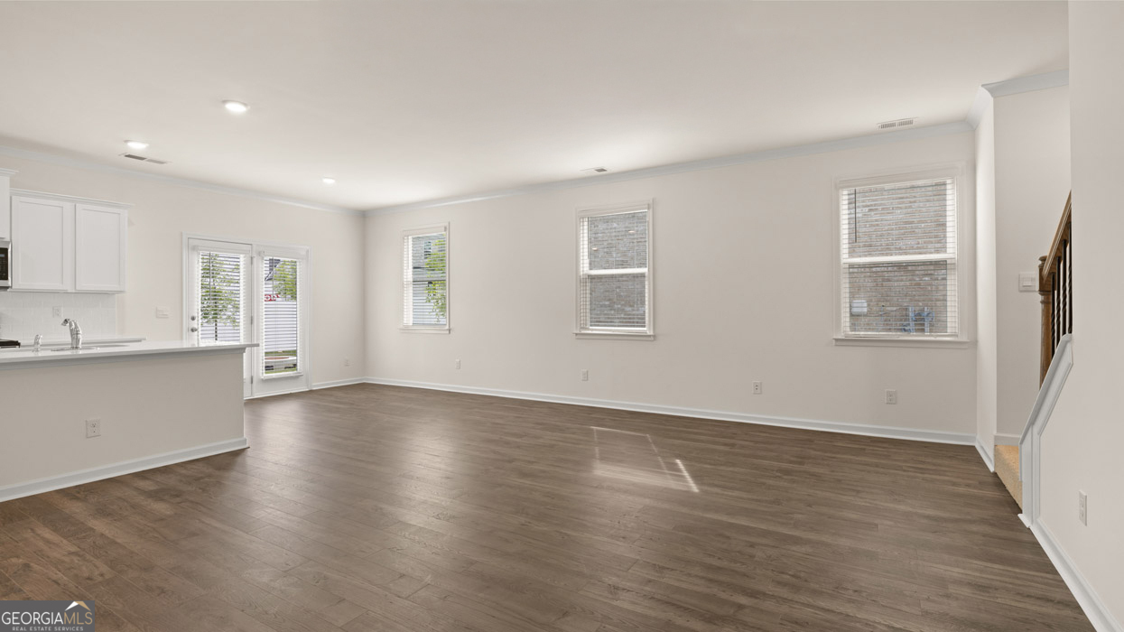 265 Sound Circle, Unit 152 Stockbridge, GA 30281 - Photo 12 of 54 a view of an empty room with wooden floor and a window