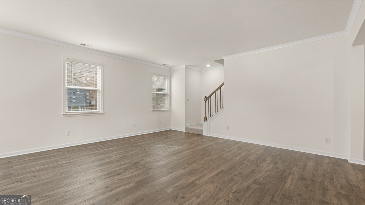 265 Sound Circle, Unit 152 Stockbridge, GA 30281 - Photo 13 of 54 an empty room with wooden floor and windows