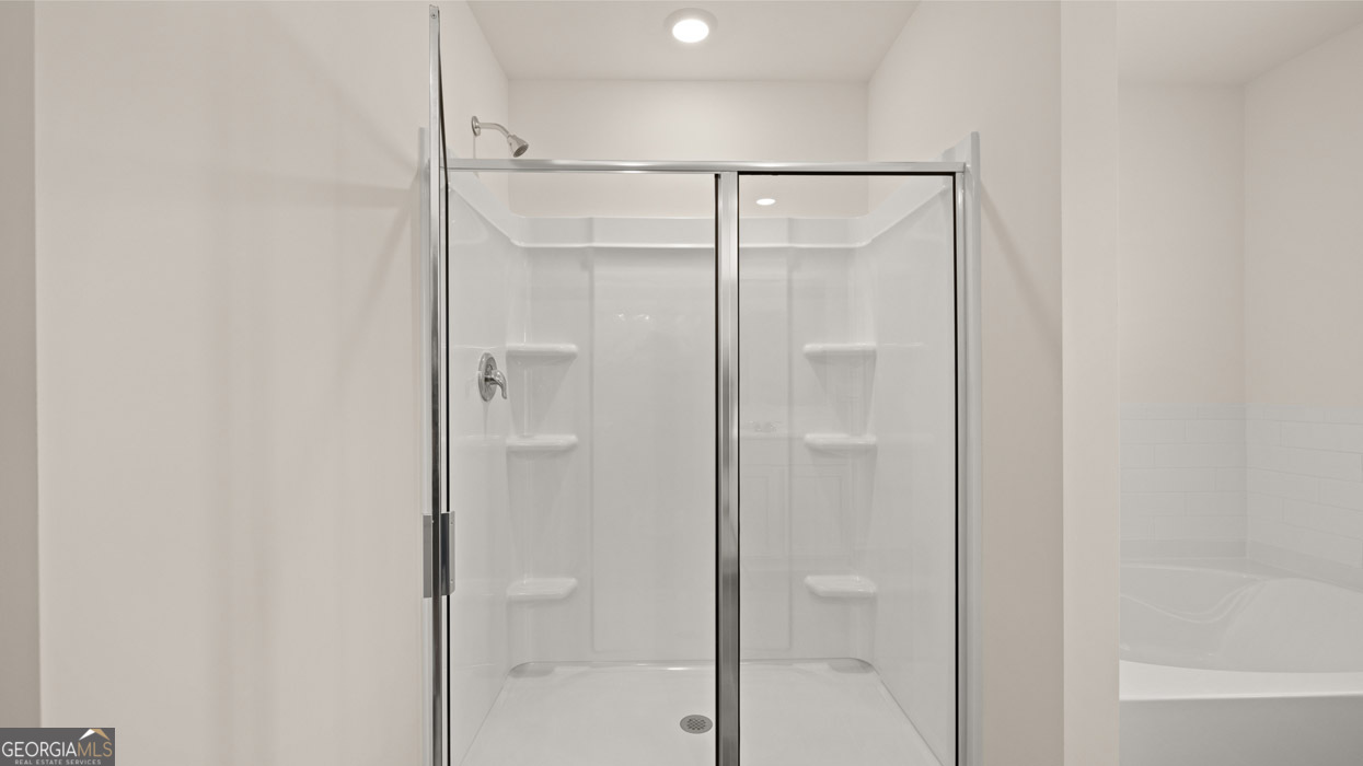 265 Sound Circle Stockbridge, GA 30281 - Photo 16 of 30 a bathroom with a glass shower door