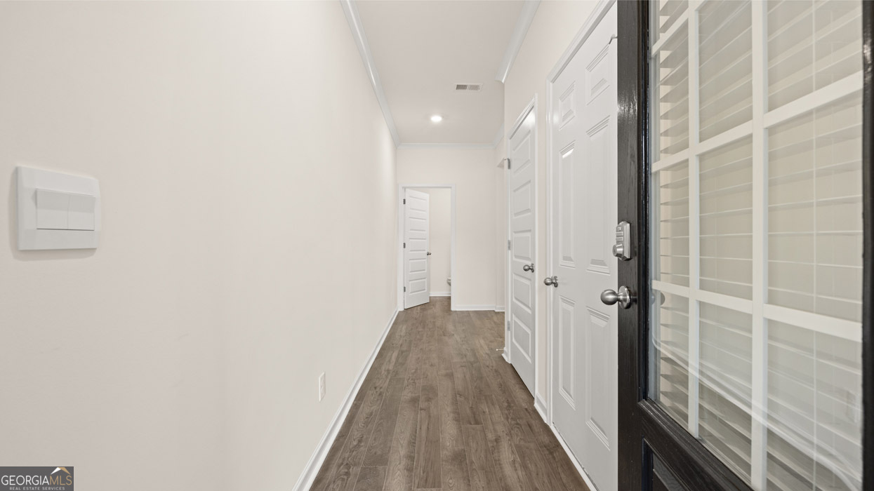 265 Sound Circle Stockbridge, GA 30281 - Photo 2 of 30 a view of a hallway with wooden floor and a bathroom