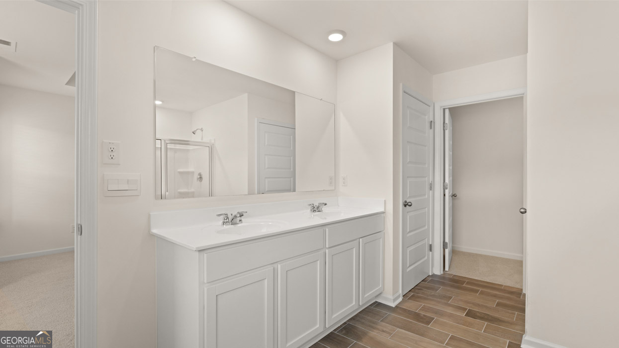 265 Sound Circle, Unit 152 Stockbridge, GA 30281 - Photo 21 of 54 a spacious bathroom with a sink and a mirror