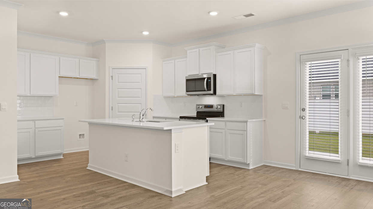 265 Sound Circle Stockbridge, GA 30281 - Photo 3 of 30 a kitchen with cabinets a sink and appliances