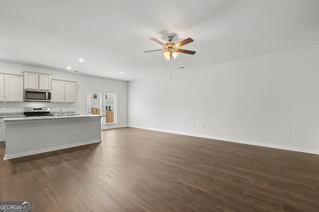 a view of kitchen with microwave and cabinets