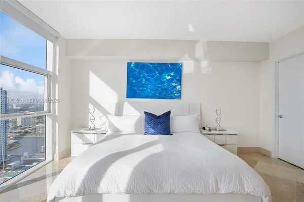 a bedroom with a large bed and a window