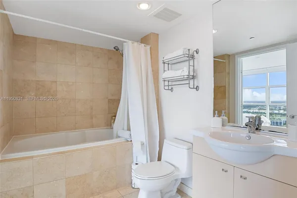 a bathroom with a sink a toilet and a bathtub