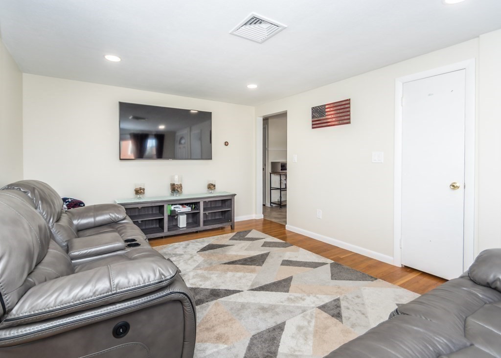89 Pine Hill Circle Waltham, MA 02451 - Photo 11 of 32 a living room with furniture and a flat screen tv