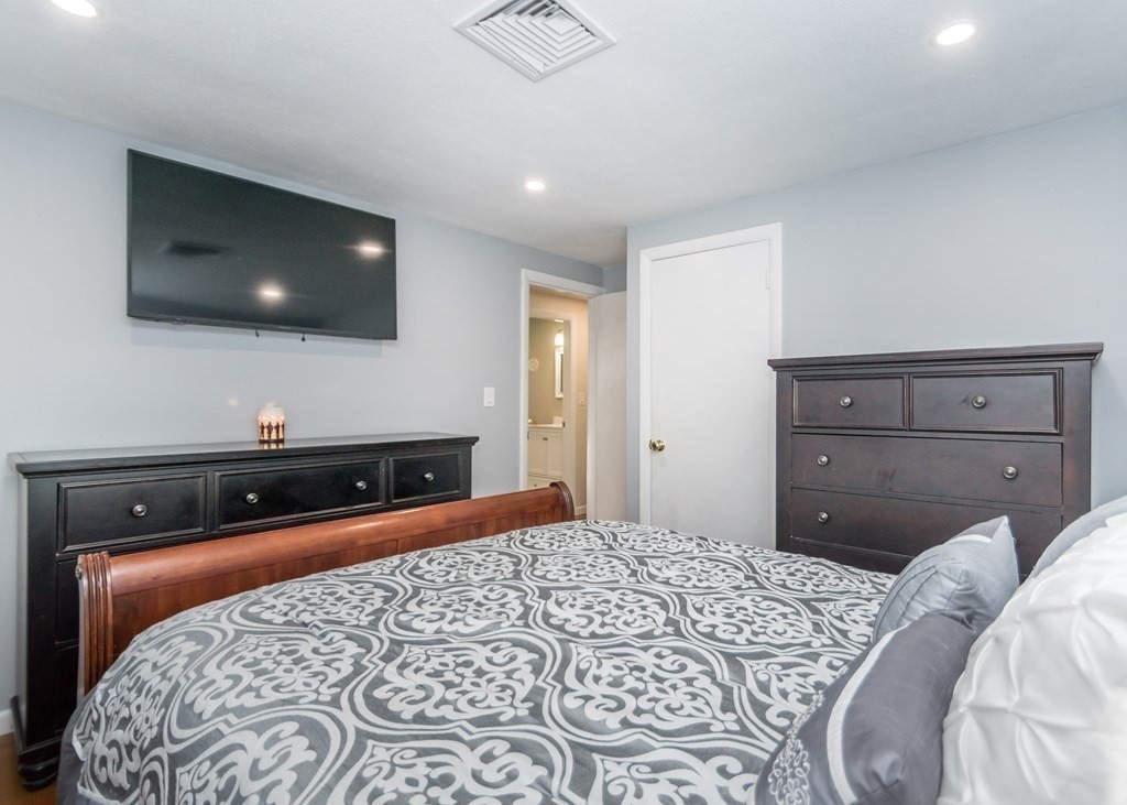 89 Pine Hill Circle Waltham, MA 02451 - Photo 15 of 32 a bedroom with a bed and a flat screen tv