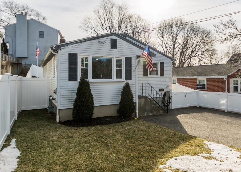 89 Pine Hill Circle Waltham, MA 02451 - Photo 2 of 32 a front view of a house with a yard
