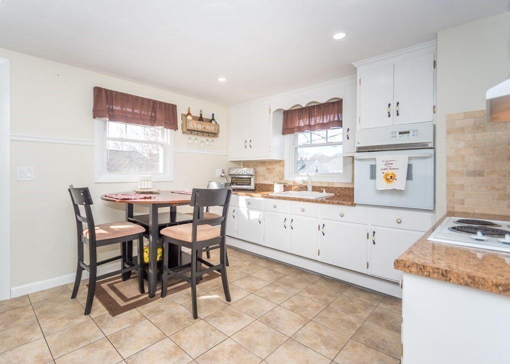 89 Pine Hill Circle Waltham, MA 02451 - Photo 4 of 32 a view of kitchen with cabinets table and chairs