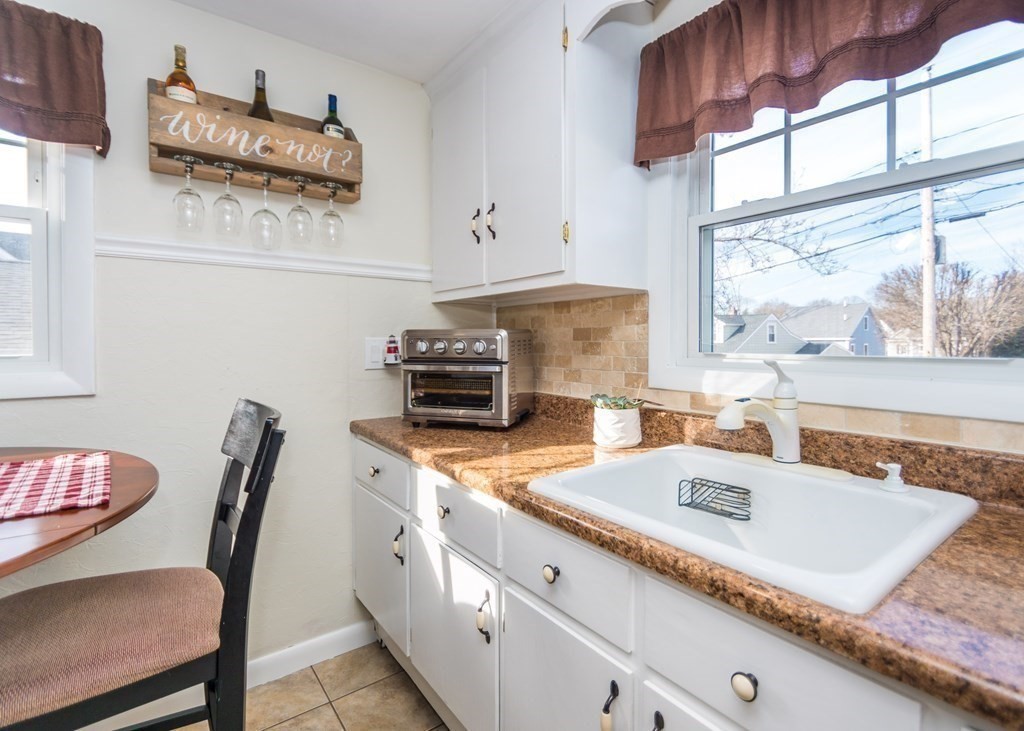 89 Pine Hill Circle Waltham, MA 02451 - Photo 7 of 32 a kitchen with stainless steel appliances granite countertop a sink a stove and a counter space