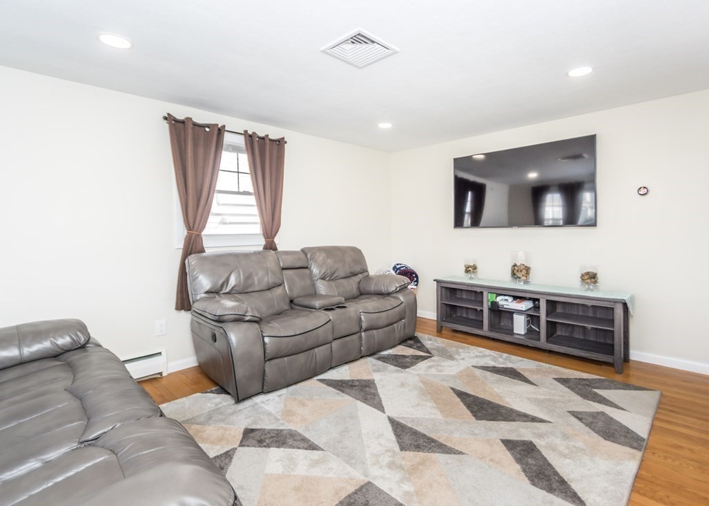 89 Pine Hill Circle Waltham, MA 02451 - Photo 10 of 32 a living room with furniture and a flat screen tv